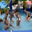 Groupe d'enfants du quartier de La Noue jouant dans une piscine gonflable