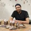 Mahdi Borgi assis à une table avec ses chocolats présentés devant lui